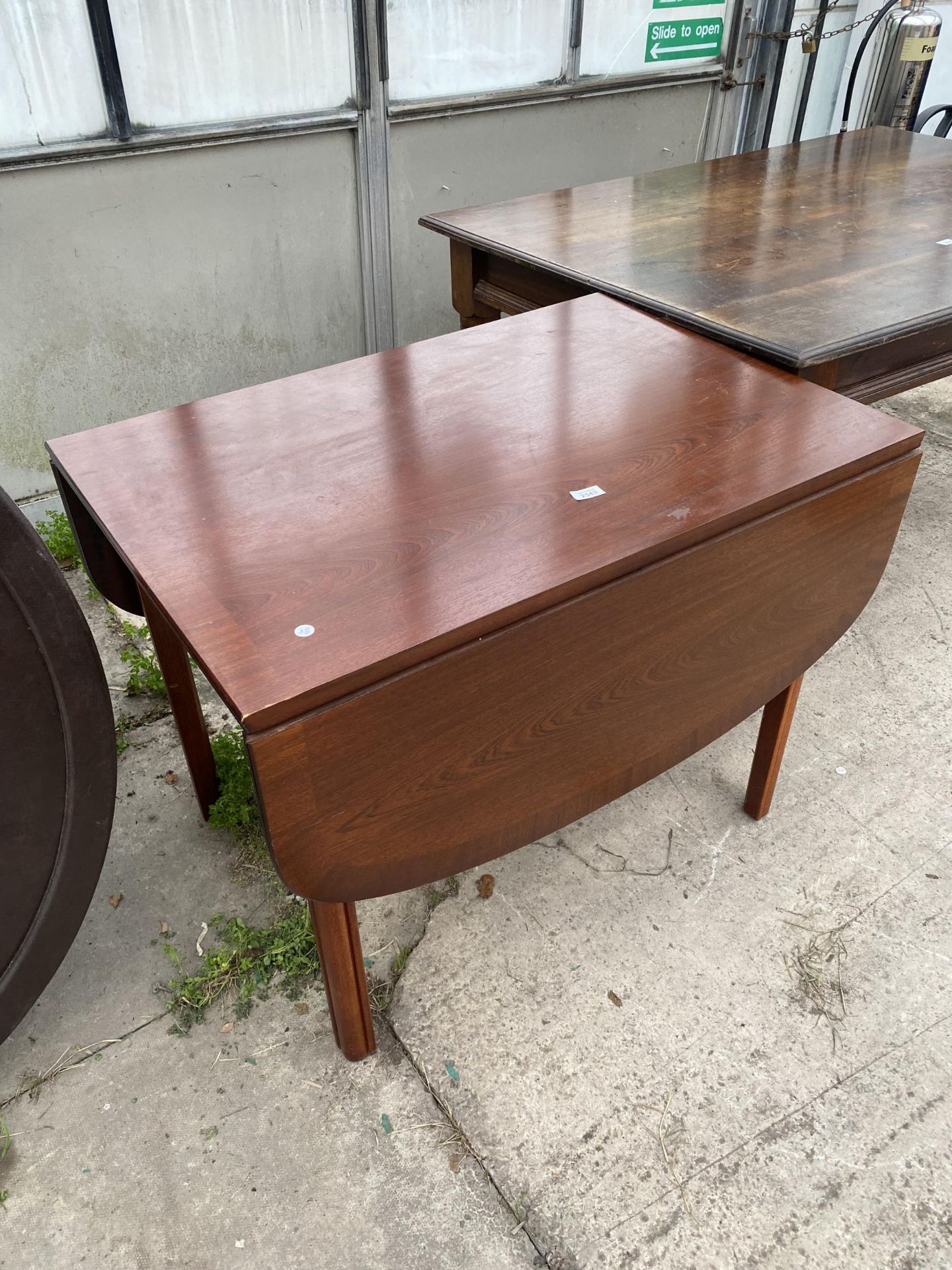 A MODERN CROSSBANDED DROP-LEAF TABLE