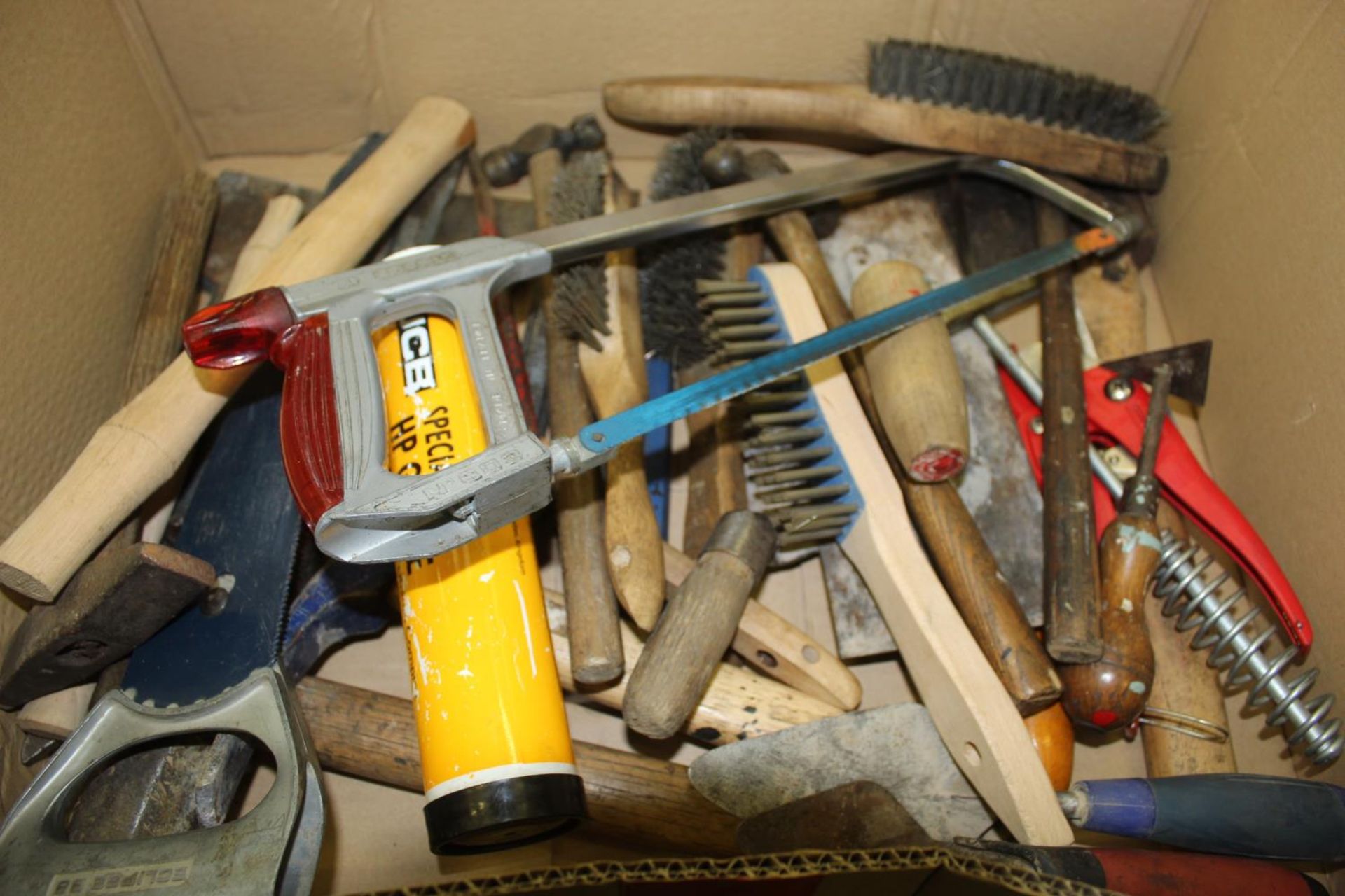 A BOX CONTAINING SAW WIRE BRUSHES, SAWS, GREASE, TROWELS ETC