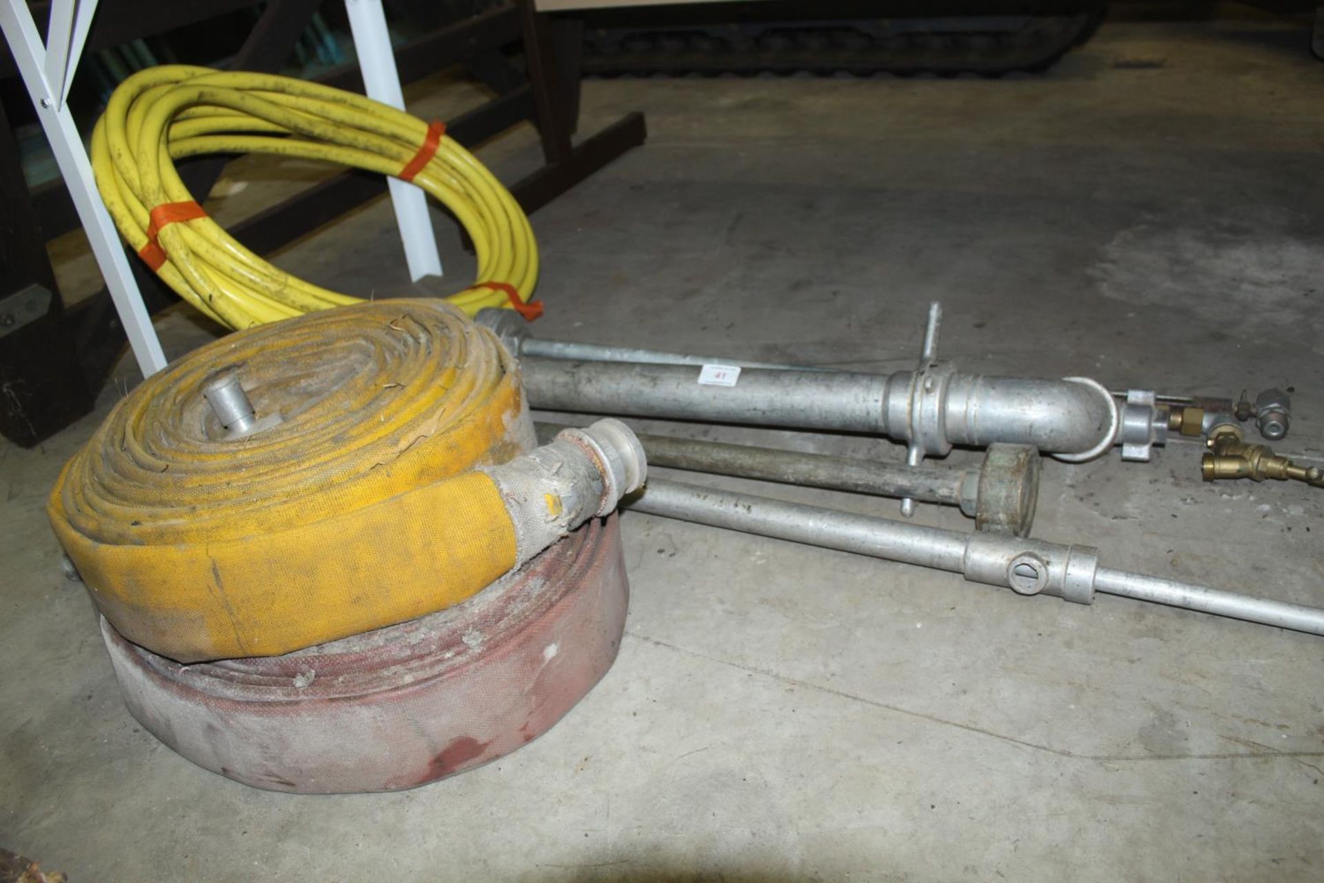 TWO REELS OF LAY FLAT HOSE, A REEL OF PLASTIC PIPE AND A STAND PIPE ETC