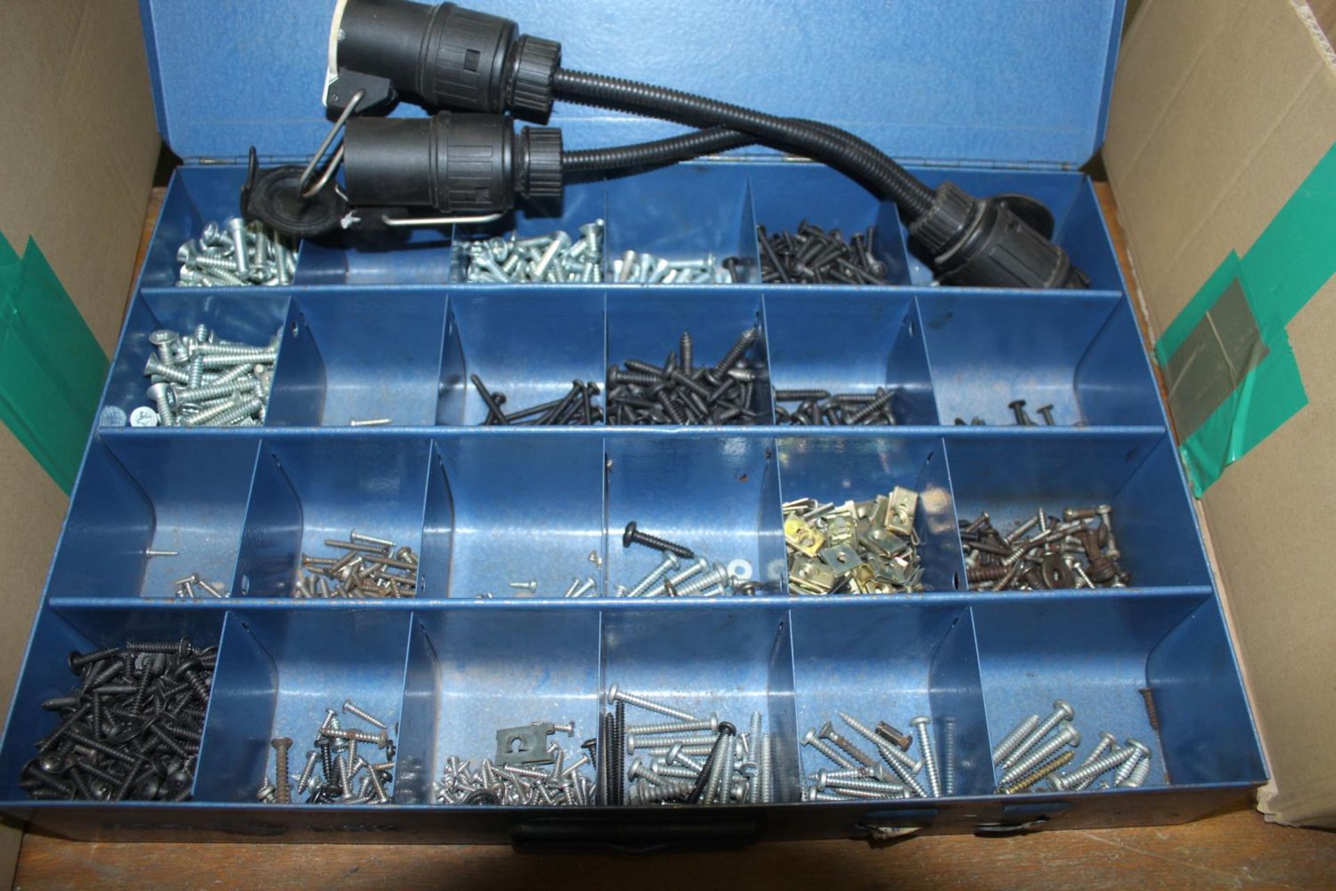 A TWENTY FOUR COMPARTMENT METAL STORAGE BOX WITH CONTENTS TO INCLUDE SCREWS AND A LANDROVER