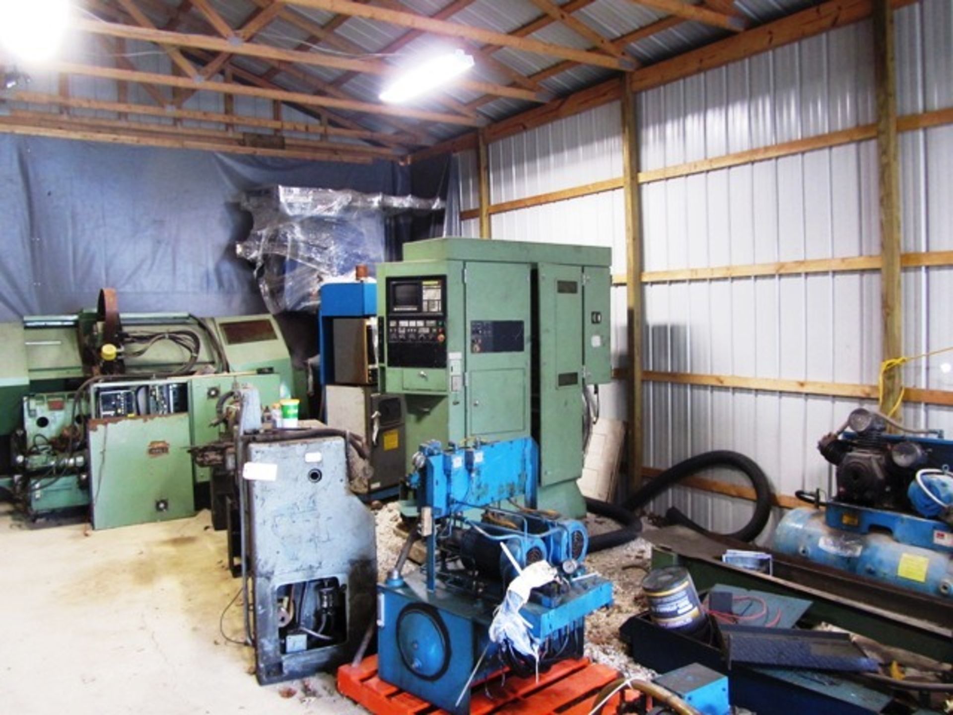 Assorted Machines in Area consisting of Hydraulic Unit, Manual Lathe, Chip Conveyors, CNC Machine