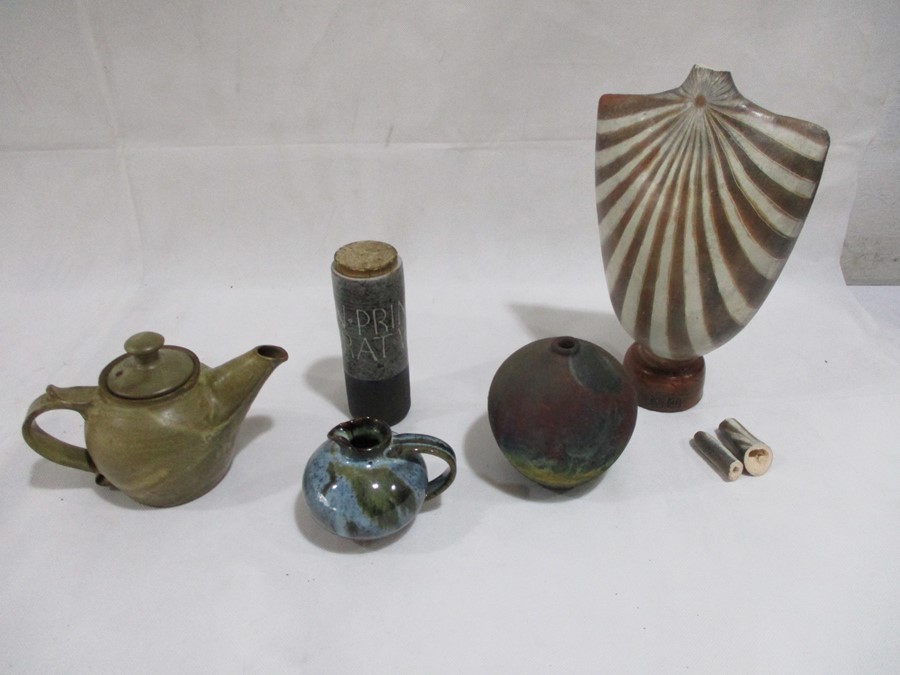 A collection of studio pottery including a teapot, small jug, and usual bust shape vase A/F