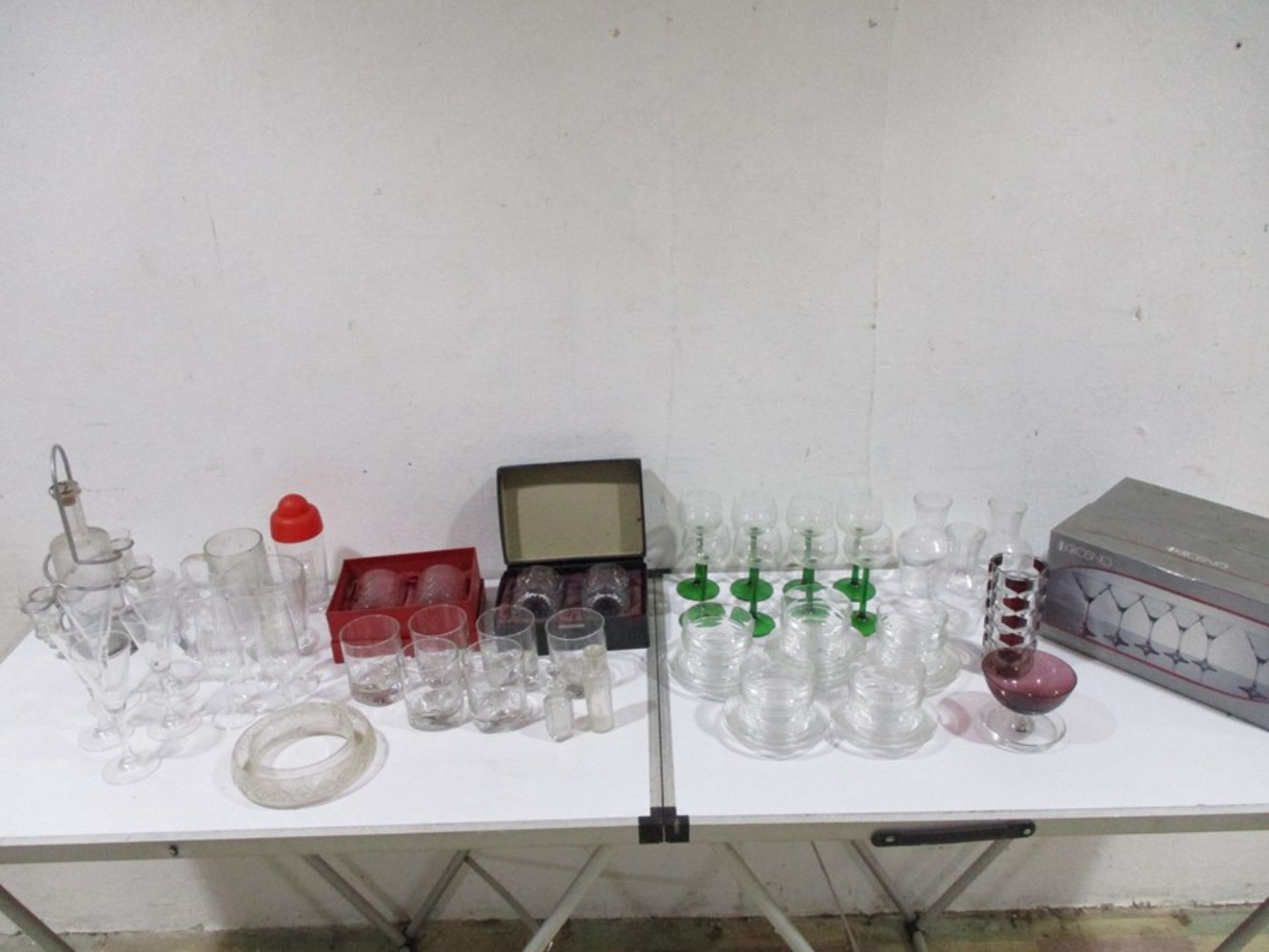 A large quantity of glassware in two boxes including tumblers, martini glasses etc.