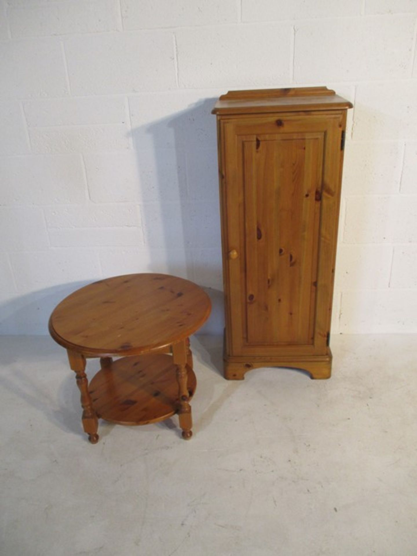 A Ducal pine cupboard along with a pine coffee table