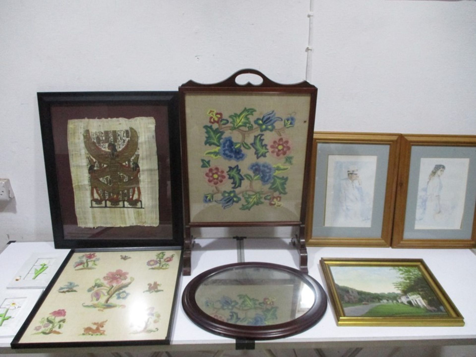 An assortment of various pictures, prints, embroidery, fire screen etc.