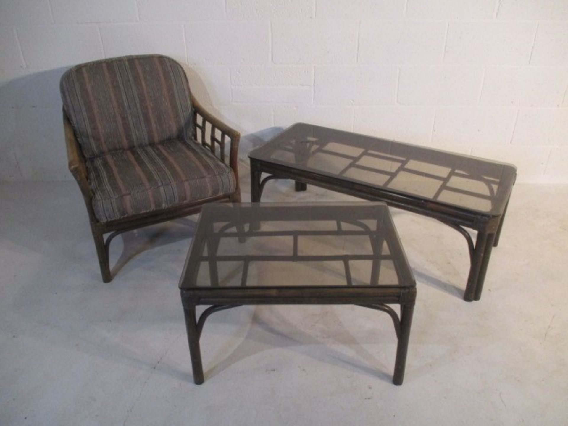A conservatory chair along with two similar coffee tables