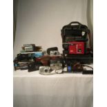 A collection of various cameras and video cameras including kodak Disc 6000, Pentax, Kodak, JVC VHSC