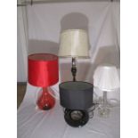 A collection of four various lamps