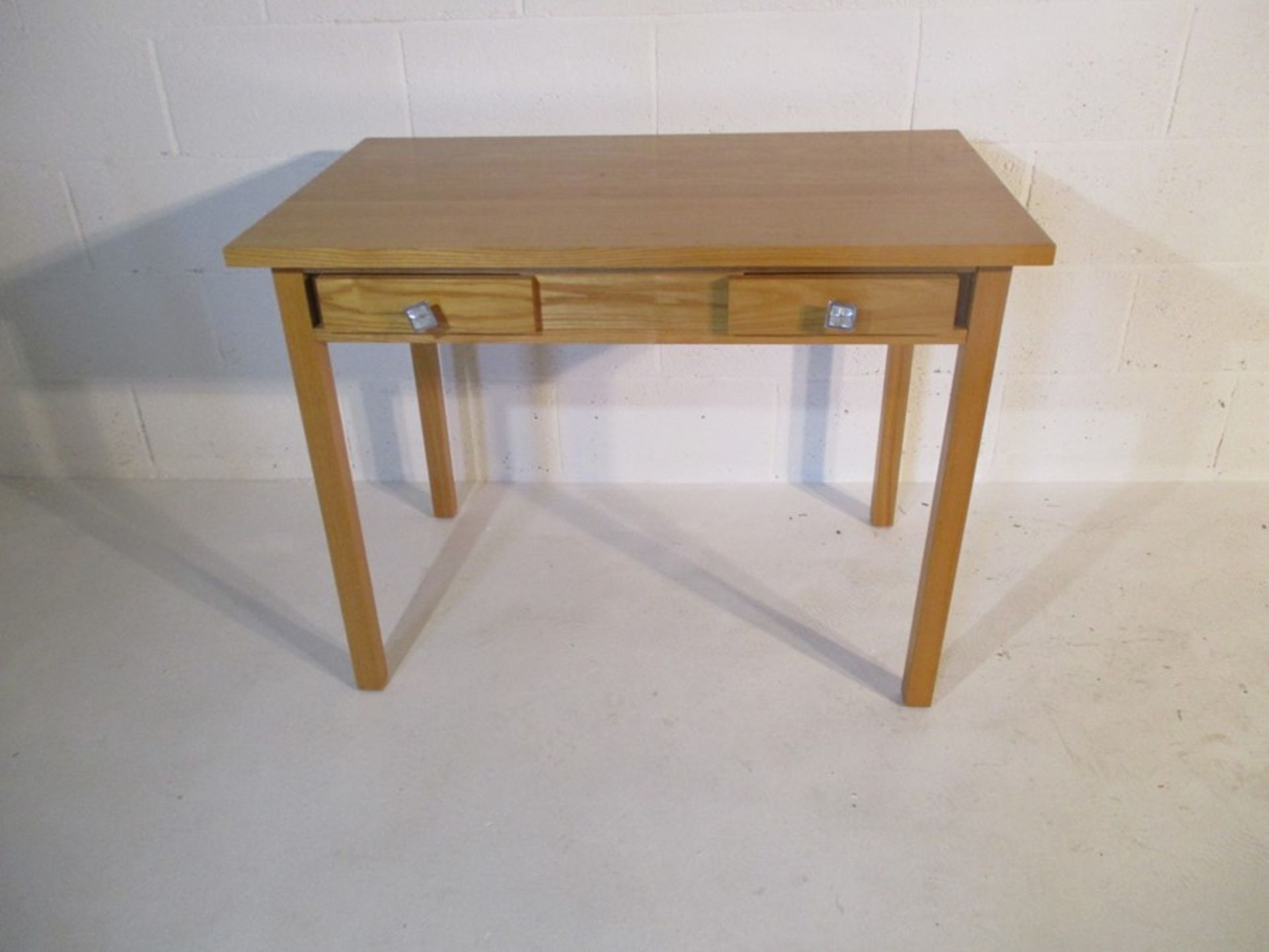 A modern light oak table with two small drawers