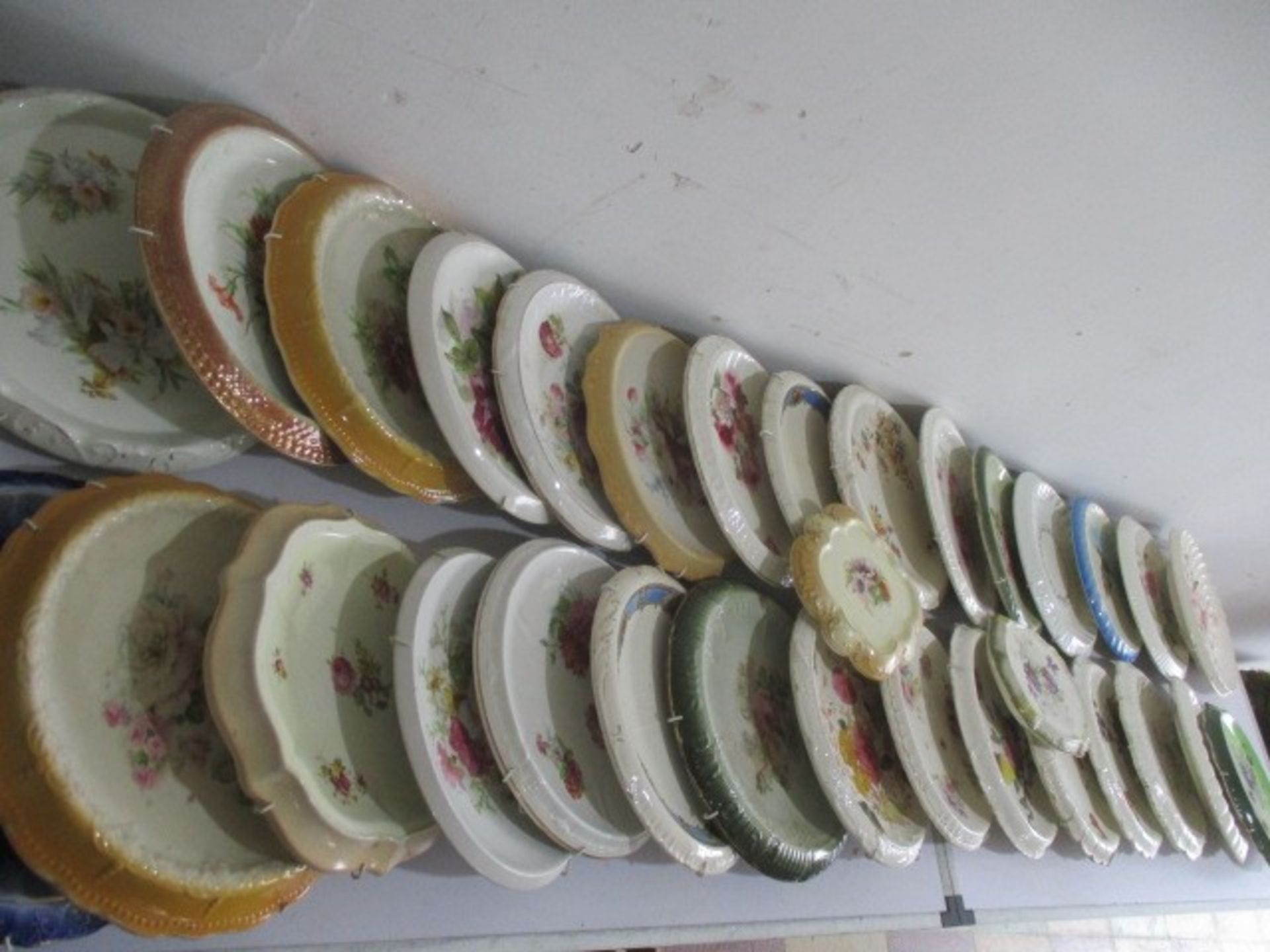 A large collection of bread plates with wall hangings