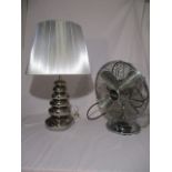 A chrome effect lamp and fan