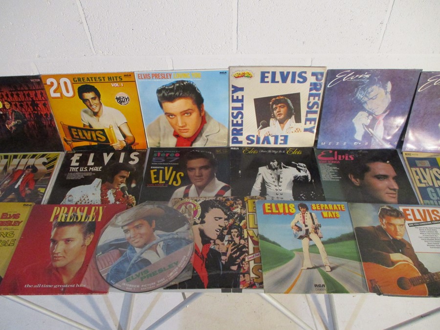 A collection of Elvis Presley vinyl records including Elvis Greatest Hits double special pink