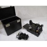 A Singer portable sewing machine No 221K1, together with accessories, pedal, instruction booklet,