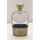 A cut glass flask with hallmarked silver gilt top