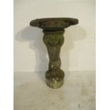 A concrete birdbath with a cherub base - height 74cm