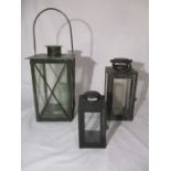 Three metal and glass candle lanterns
