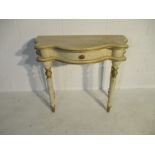 A modern serpentine fronted hall table with crackle glaze decoration