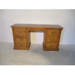 An oak pedestal desk with six drawers
