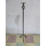 A wrought iron candle holder - height 114cm