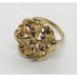 A 14ct gold dress ring set with 7 small rubies - total weight 4.6g
