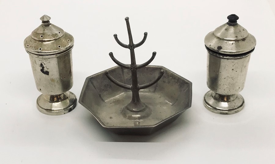 A hallmarked silver ring holder along with a pair of silver salt and pepper pots