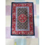 An Eastern ground rug with central floral design - Overall size 94cm x 63cm