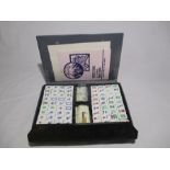 A Mahjong set in black travel case