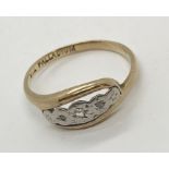 A 9ct gold and palladium diamond three stone ring