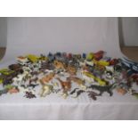 A collection of die cast cars and plastic toy animals