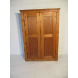 A large pine cupboard H181cm W122cm D53cm