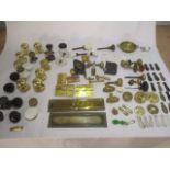 A collection of assorted vintage door fixtures including handles, letterboxes etc