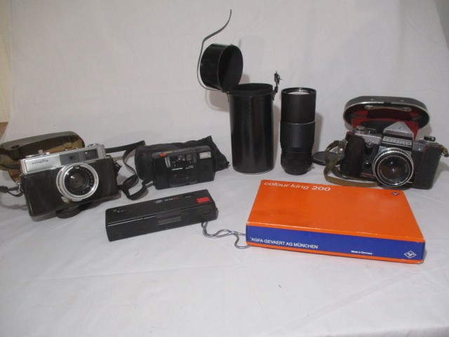 A collection of vintage cameras and lenses including Minolta and Praktica