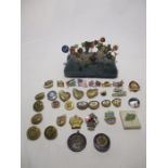 A collection of various lapel badges including a "On War Service 1914" badge, KGFS badge, a set of