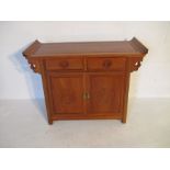 A Chinese hardwood sideboard/altar table with two drawers and cupboard under
