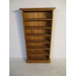 A small pine freestanding bookcase, height 125cm x 61cm width