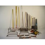A collection of various tools and other items including spades, pitchforks, fire crate, saws,