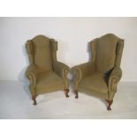 A pair of Queen Anne style wingback armchairs