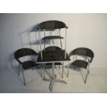 A set of four rattan effect garden chairs and matching tip up table