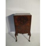 A walnut veneered writing cabinet with two drawers under on cabriole legs