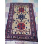 An oriental rug with stylised design and Greek border pattern
