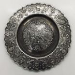 A small Dutch silver salver decorated with a central hunting scene and cherubs to the rim