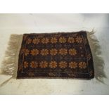 A small red ground rug - length 82cm, width 44cm