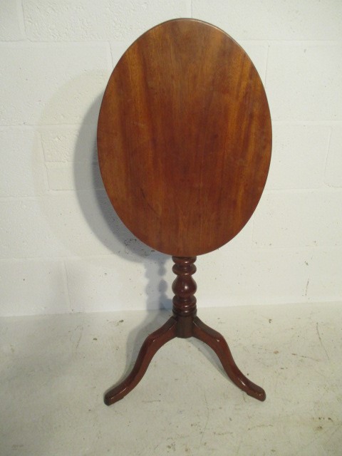 A Georgian mahogany oval tip up table on tripod base