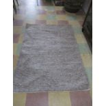 A modern grey woven rug 118cm x 170cm