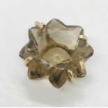 A flower shaped smoky topaz pendant set in unmarked gold mount (probably 9ct)