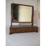 A Georgian toilet mirror with inlaid detailing along three drawers