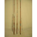A collection of three split cane fishing rods.