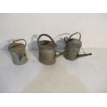 Three vintage galvanised watering cans