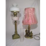 A Victorian oil lamp with glass shade on brass base along with one other
