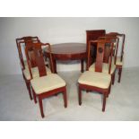 A Chinese hardwood extending table and six chairs